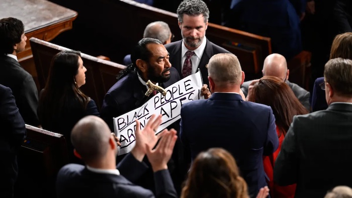 Rep. Al Green holds sign protesting Trump, sparking confrontation and being escorted out of the Hous...