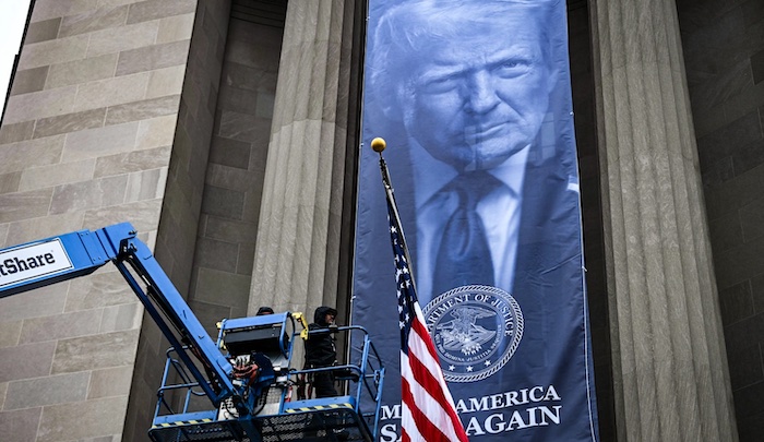 A Trump banner reading “Make America Safe Again” was displayed outside the Justice Department, signa...
