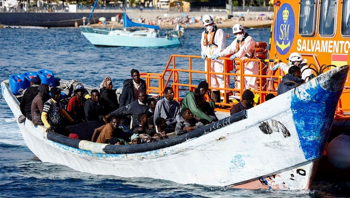Spain moves to grant legal status to hundreds of thousands of undocumented migrants, promising jobs,...