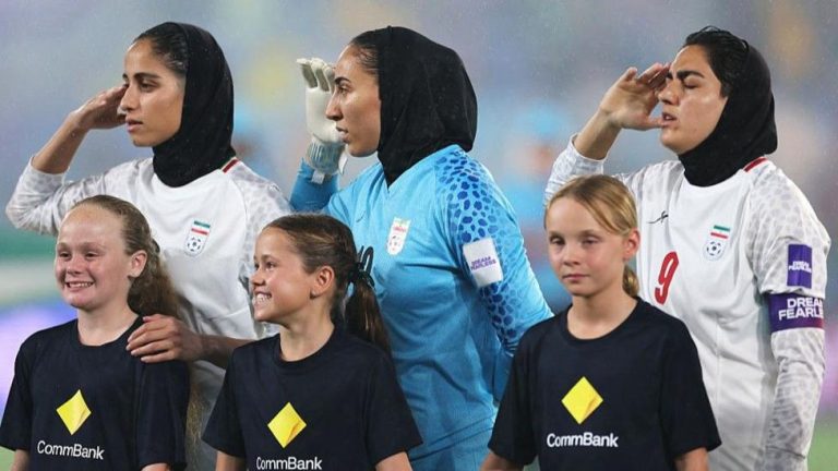 Iran’s players saluted while singing the country’s national anthem before their Asian Cup match agai...