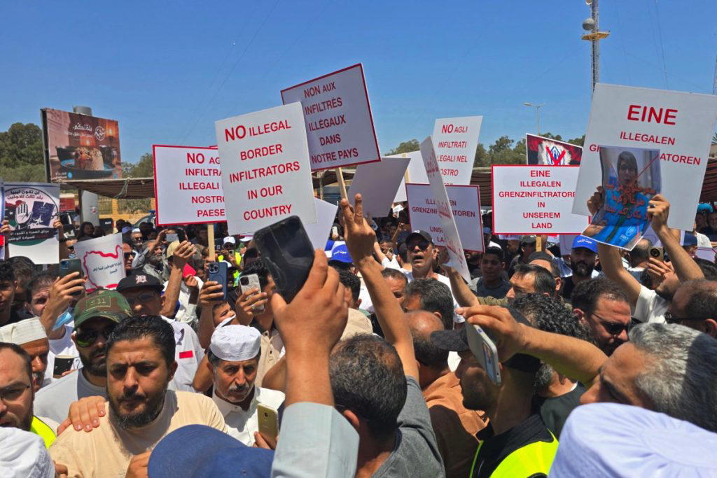 Hundreds of Libyans gathered outside the UN refugee agency headquarters in Tripoli on Thursday to pr...