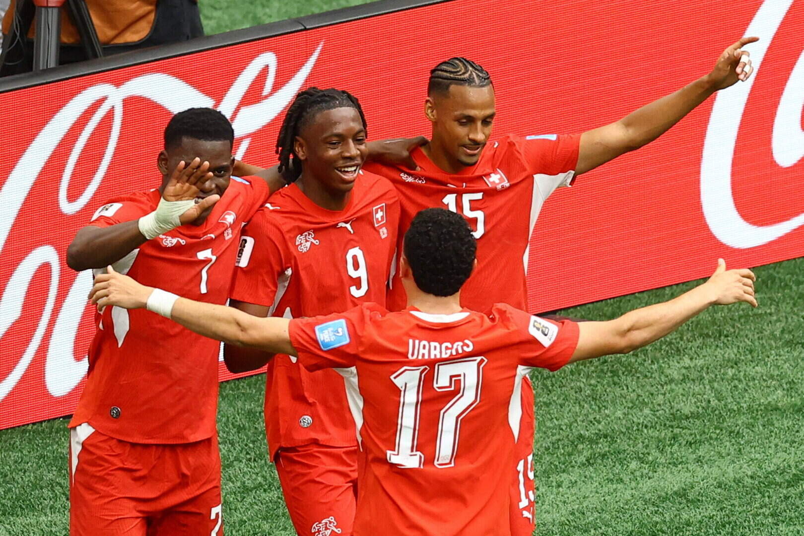 Switzerland defeat Canada 2-1 to win Group B, while the hosts also advance to the World Cup knockout...