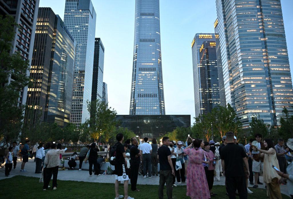 A pilot was killed when his small aircraft crashed into Beijing’s tallest building, with 13 people a...