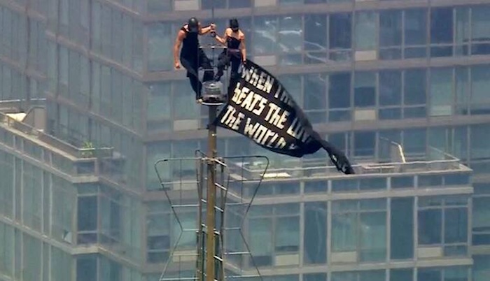 Russian climbers unfurl a peace banner, celebrate their engagement atop New York's Empire State Buil...