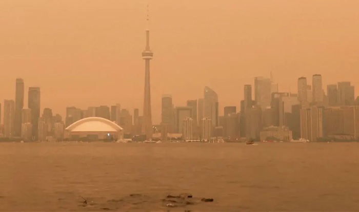 Wildfire smoke blanketed Toronto and spread into the US, prompting health alerts, event cancellation...