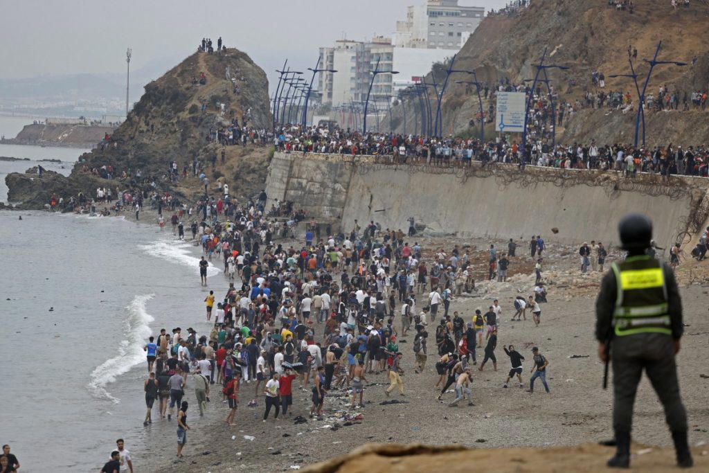 Thousands of migrants crossed overnight from Morocco into Spain’s north Africa’s Ceuta enclave, a po...