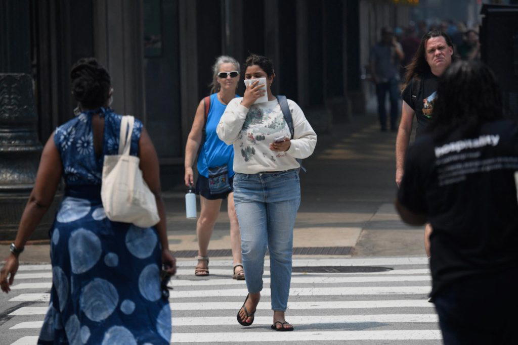Dense wildfire smoke billowing down from Canada set off unhealthy air quality alerts across the Unit...