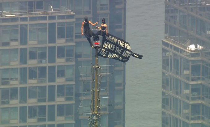 Two people were arrested on Wednesday after climbing to the top of the antenna of the Empire State B...