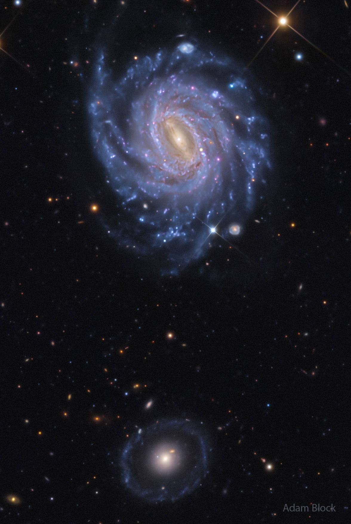 The upper galaxy might be more photogenic, but the lower galaxy is more unusual. The galaxy up top i...