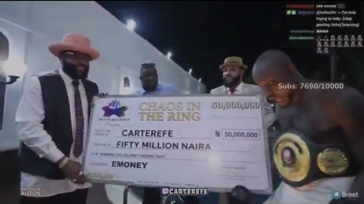 Carter Efe receives the cheque of ₦50 million from E-money for beat!ng Portable in their celebrity b...