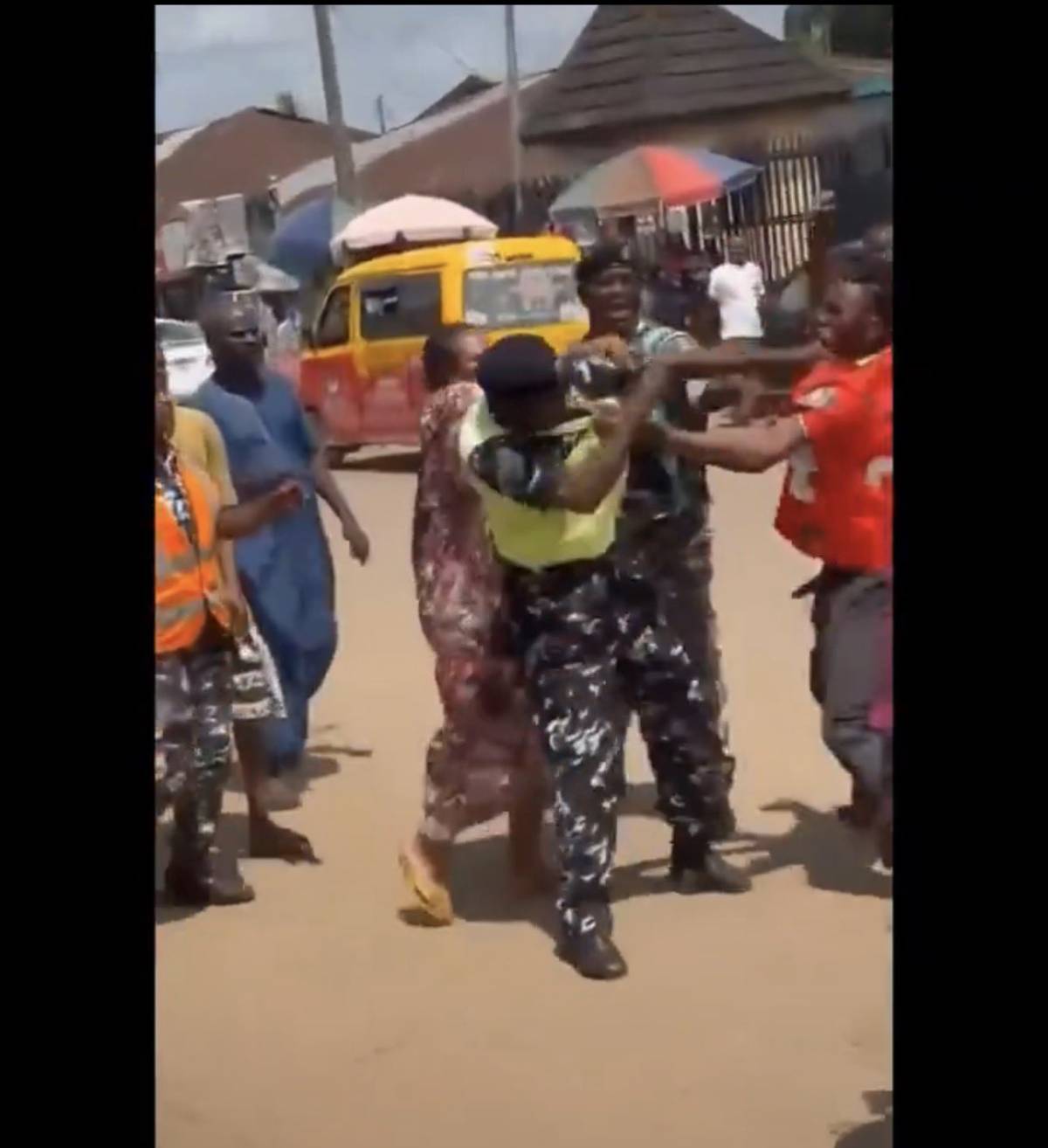 Photo of young man punching a police officer in Nigeria