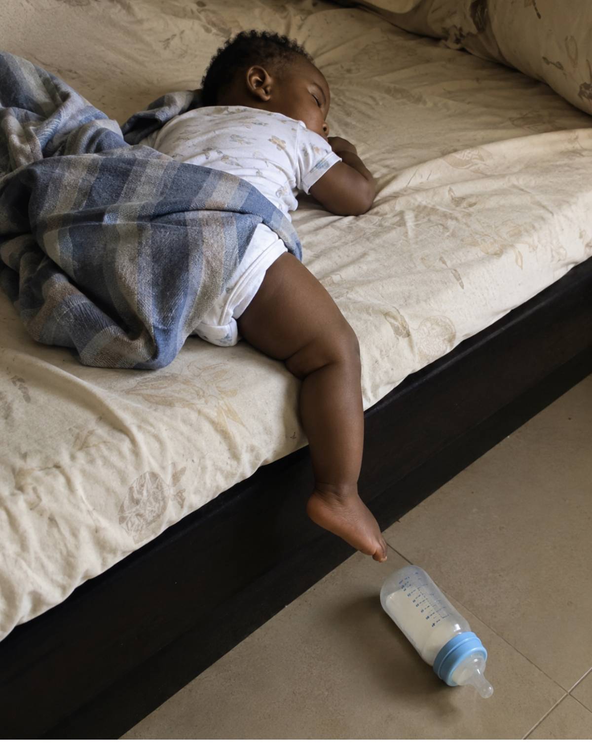 One leg on the bed... one leg hanging out... the bottle on the floor... yet sleeping like there's no...
