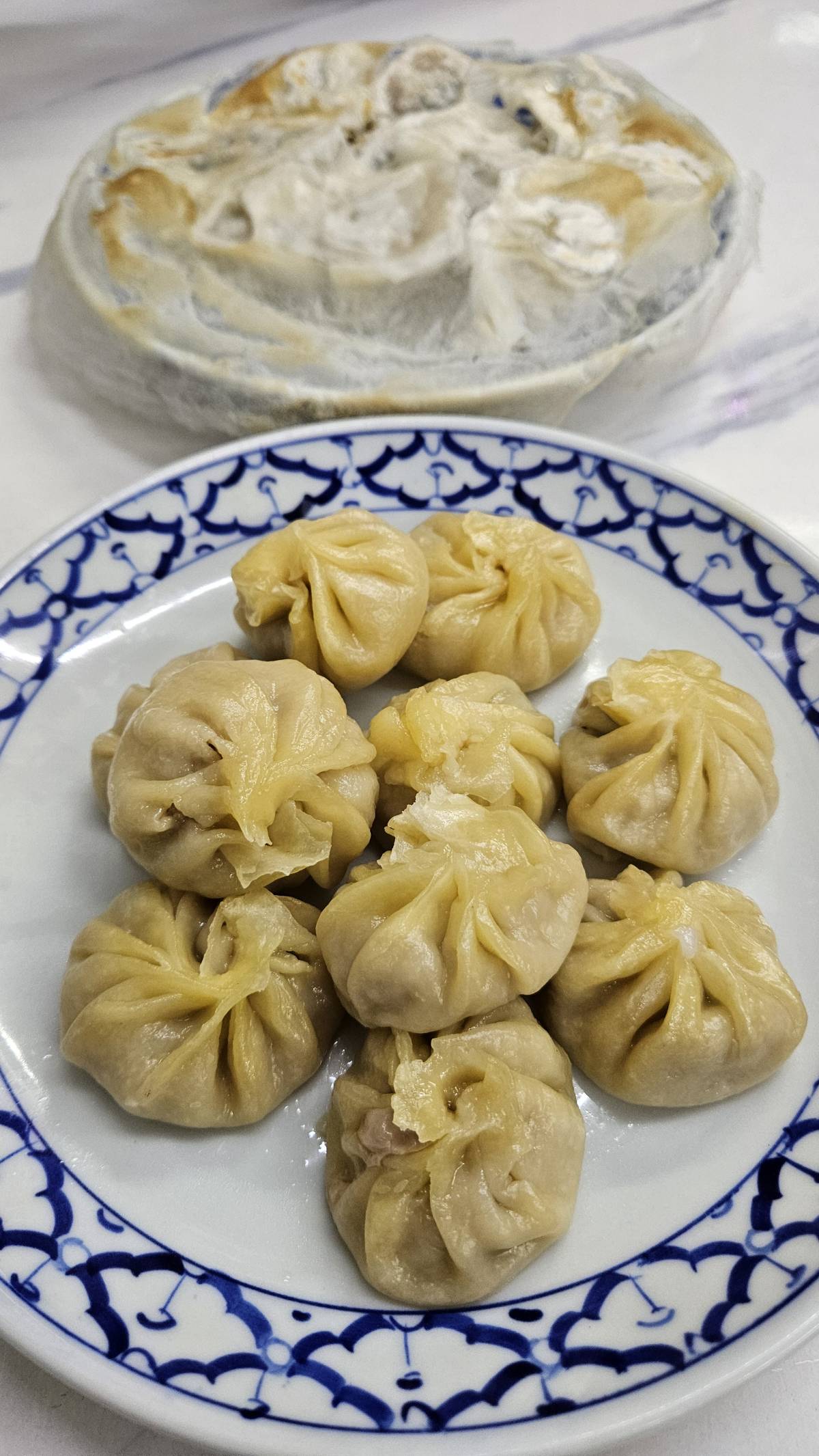 I was walking to my hotel and saw people eating dumplings at a Chinese restaurant in Bangkok. It loo...