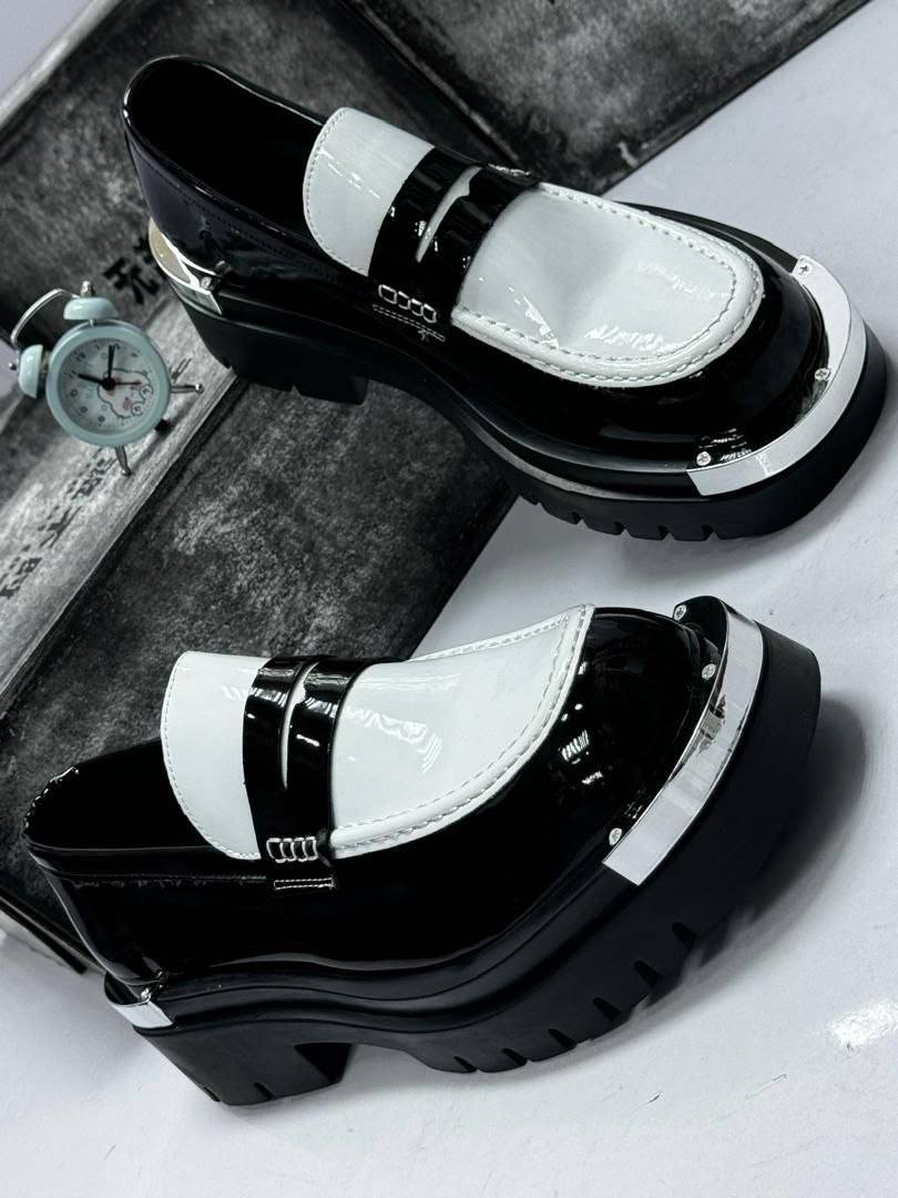 Turn heads in these sleek black-and-white platform loafers—crafted for confidence, comfort, and effo...