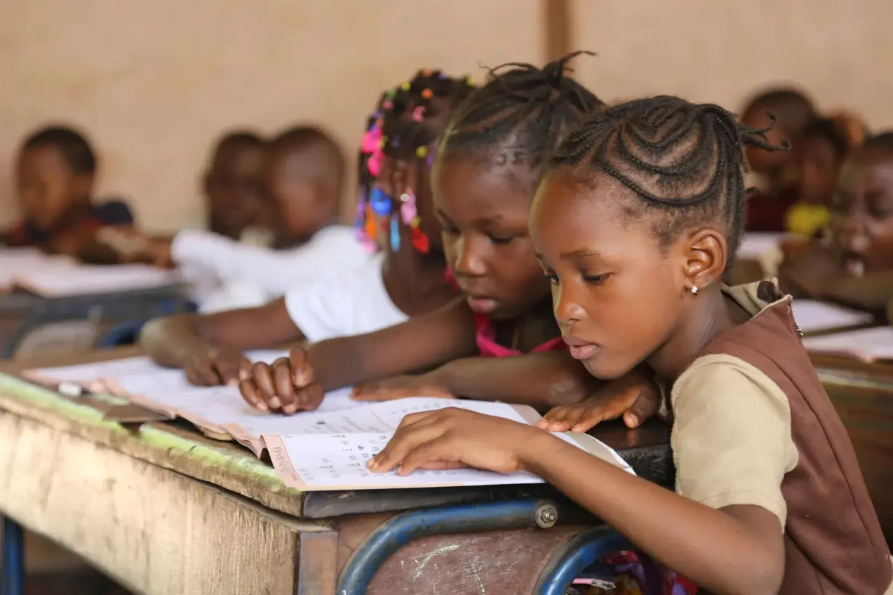 Ask why a girl in a rural community is kept home while her brother is sent to school, and the answer...