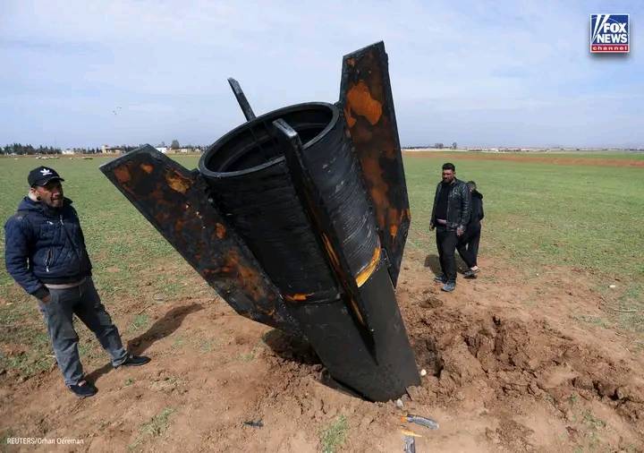 WARHEAD FALLOUT: Striking new image surfaces out of Syria showing civilians standing next to a missi...