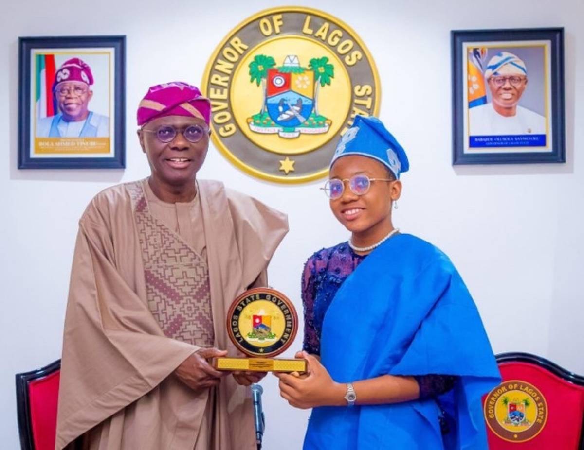 Lagos State Governor Babajide Sanwo-Olu, congratulates Esther Etiyemonu, a student at Lagos State Se...