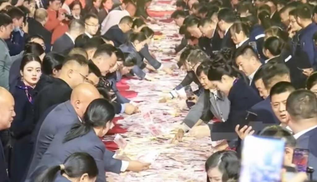 A Chinese company stunned staff by stacking $26 million in cash at its end-of-year celebration, invi...