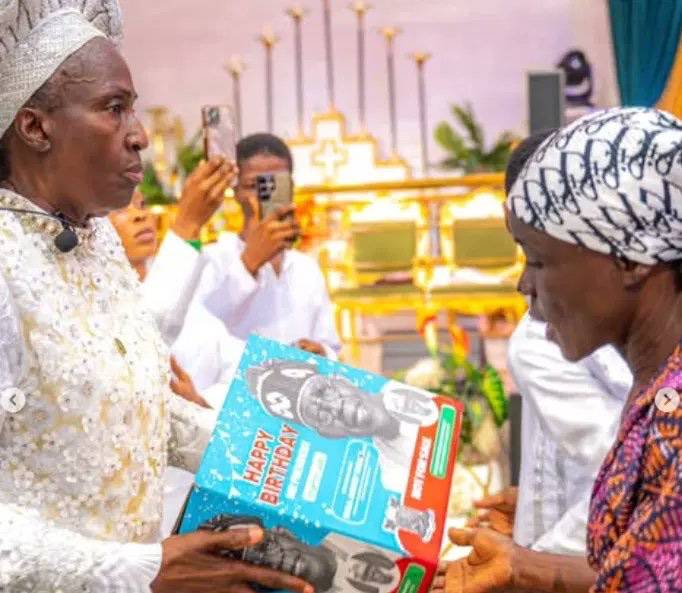 Reverend Esther Ajayi shares President Bola Tinubu-branded Easter packages in church.