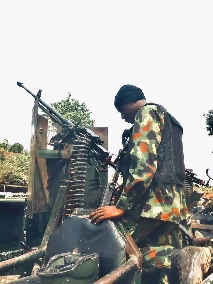 🇳🇬Before the wheels roll, before the bush swallows them he kneels. On the cold steel of a gun truck,...