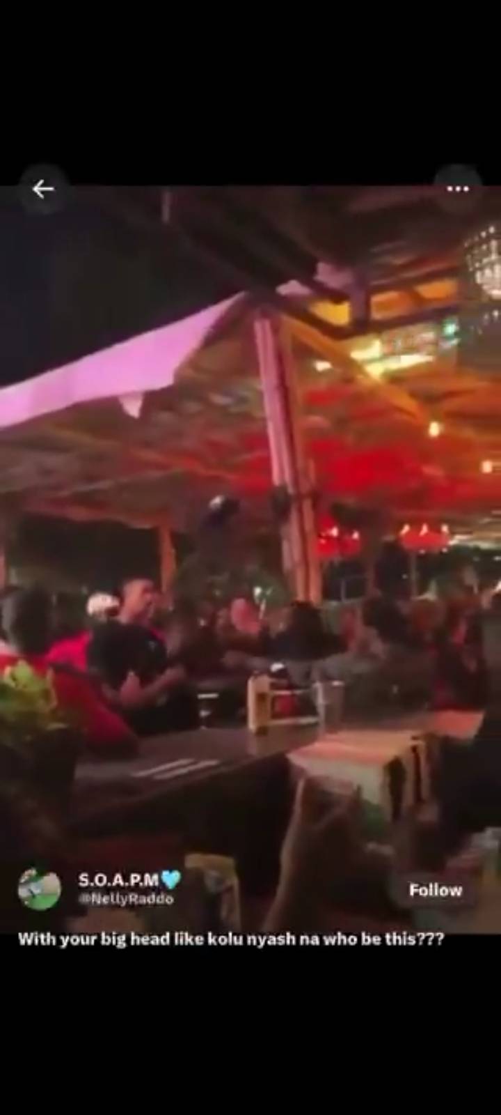 A blur picture of DJ tunez being mobbed by burna boy and his goons