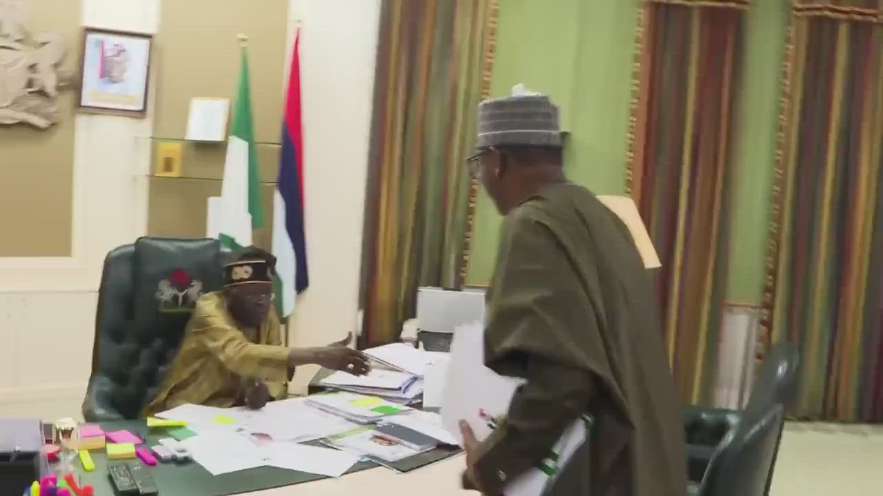 Chairman of National Sports Commission, Shehu Dikko presents a special Super Eagles jersey to Presid...
