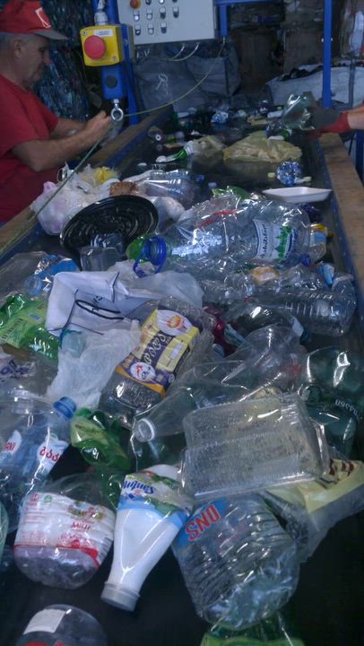 PET bottles are being sorted and compressed by machine, transforming discarded plastic into valuable...