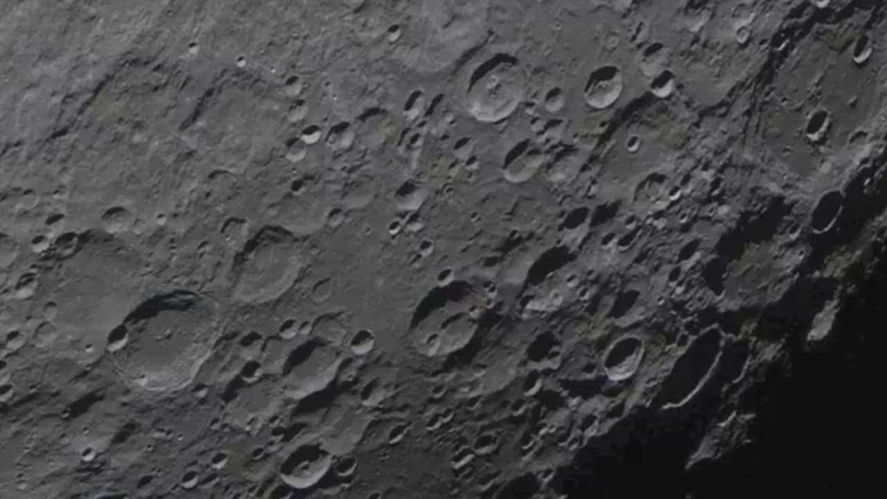 Artemis II mission showing detailed cratered terrain on the Moon's far side, captured by astronauts...