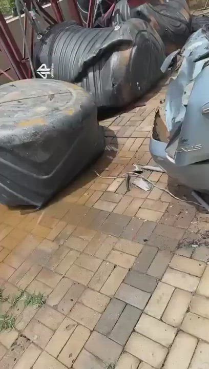 Man in shock as his car is destroyed by water tank