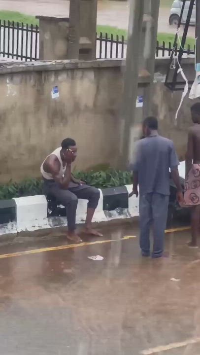 The man was seen sitting by the roadside resting after he was rescued following the flood incident i...