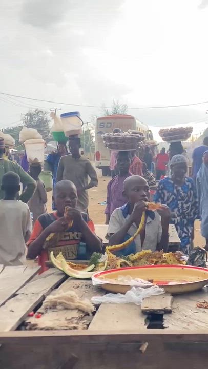 A heartbreaking sight: an Almajiri child eating from a discarded pineapple shell found in the trash....