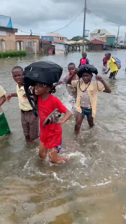 Children still take the pains in this flood to go to school. Even an average Nigerian kid smiles thr...